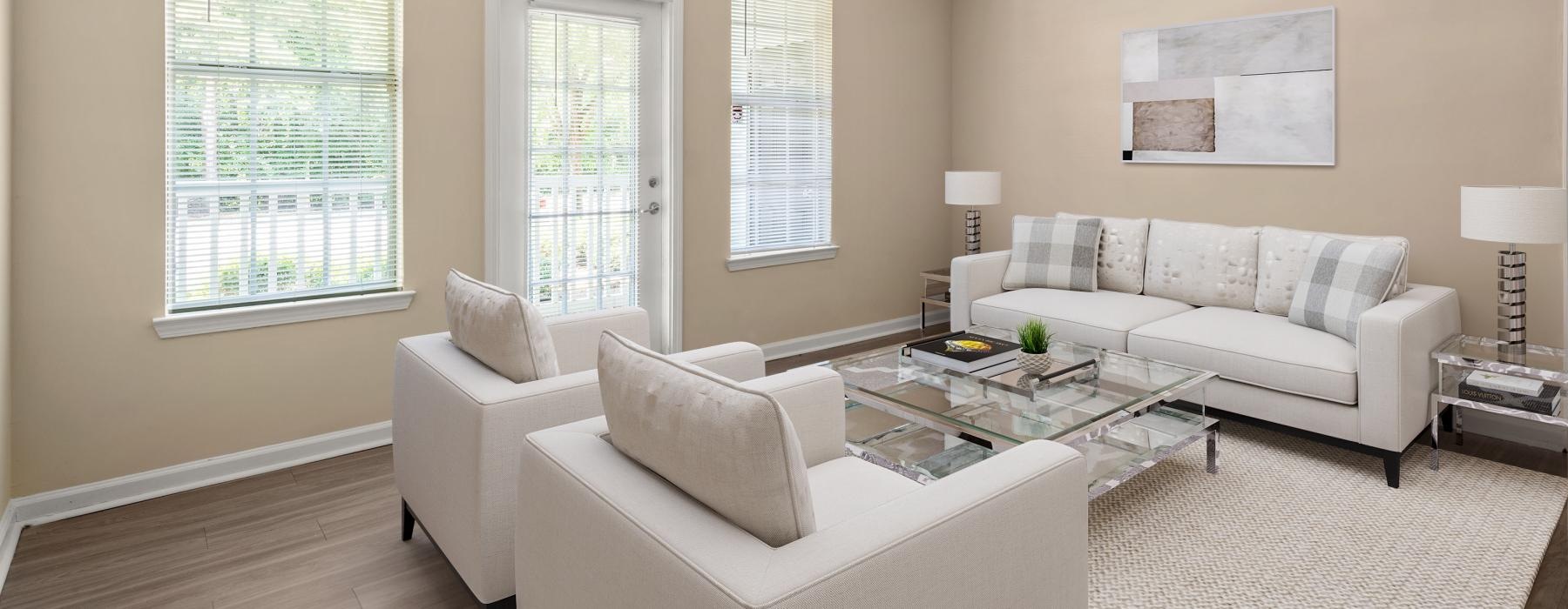 a living room with a white couch and a ceiling fan