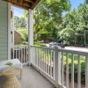 patio with a railing, chair and table