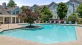 a swimming pool in front of a large building